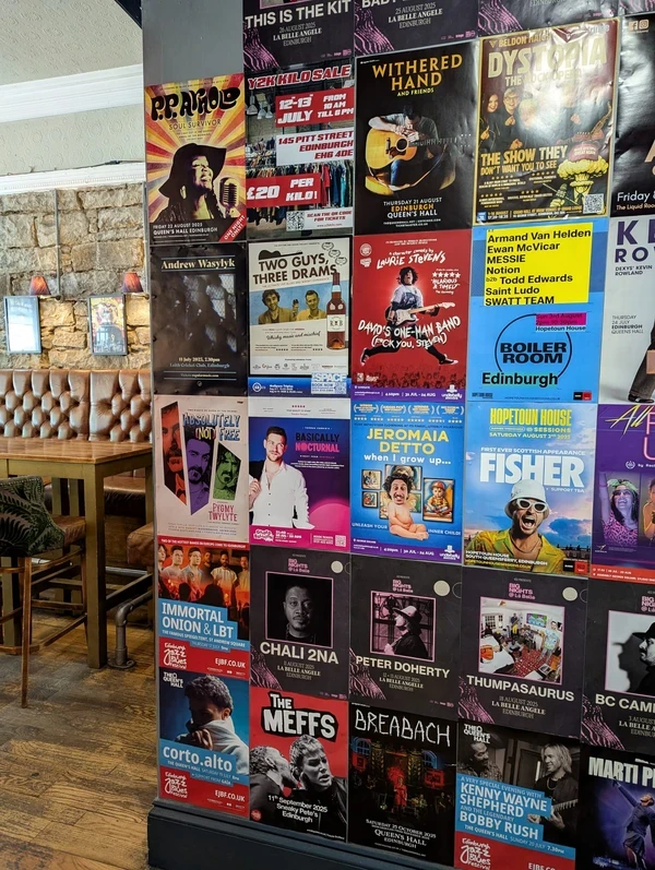 Posters on a wall in Edinburgh